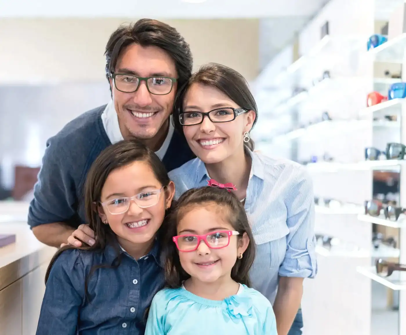 Family wearing glasses in an optical office