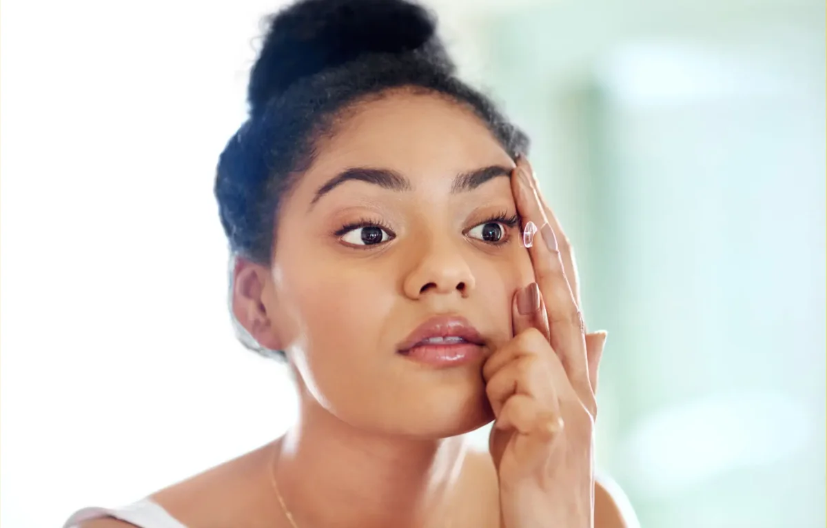 A person preparing to insert a contact lens
